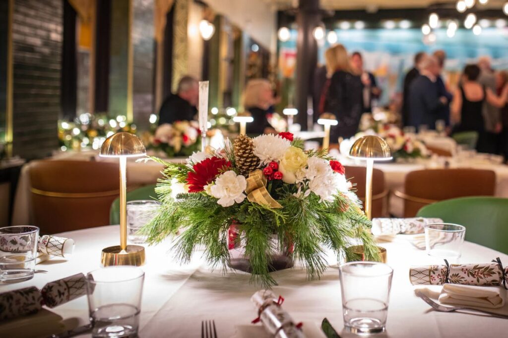 Holiday Party Tablescape With Florals And Christmas Crakers At The Bellevue Chicago In The Gold Coast