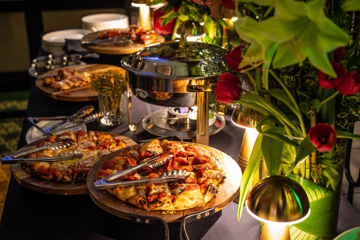 Food buffet with pizza and appetizers at The Bellevue set for holiday party