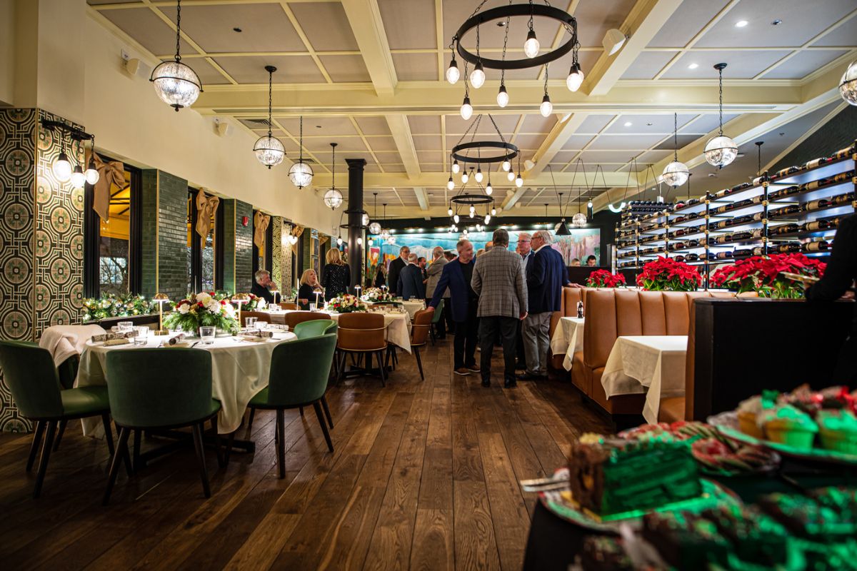 Holiday party at The Bellevue in Chicago Gold Coast. Room full of people and festive decor