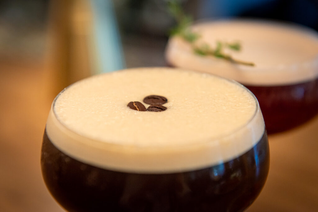 Gingerbread Espresso Martini cocktail garnished with espresso beans at The Bellevue Chicago