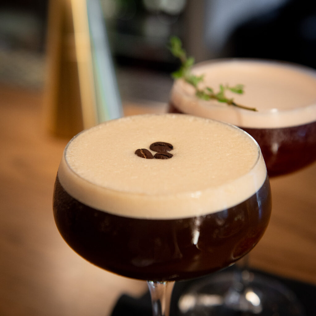 Gingerbread Espresso Martini cocktail garnished with espresso beans at The Bellevue Chicago in the Gold Coast